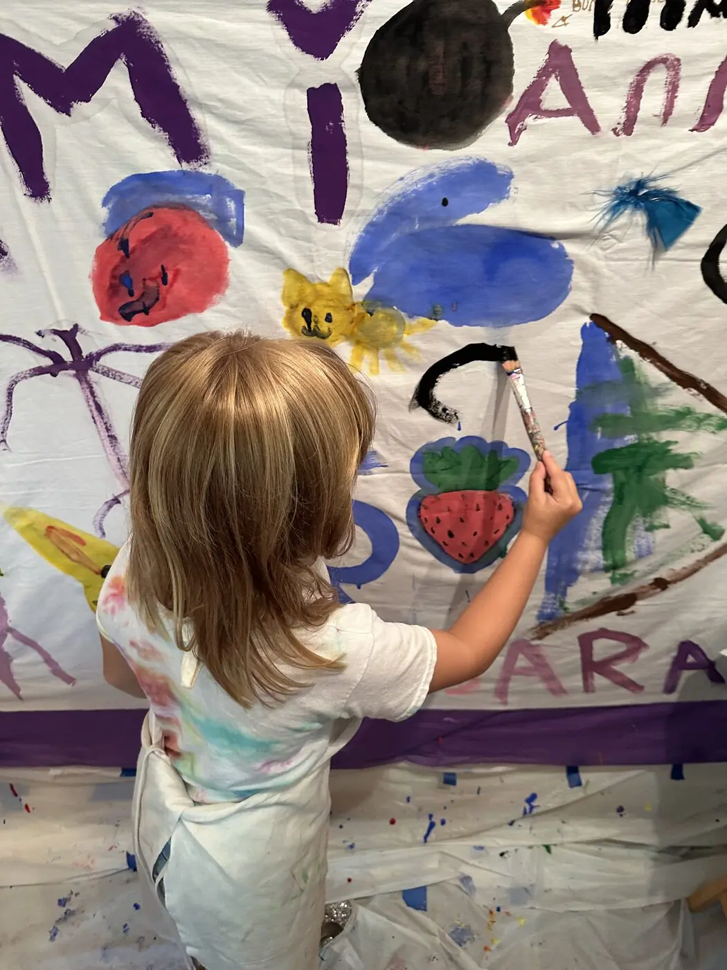 Hands painting on a large canvas
