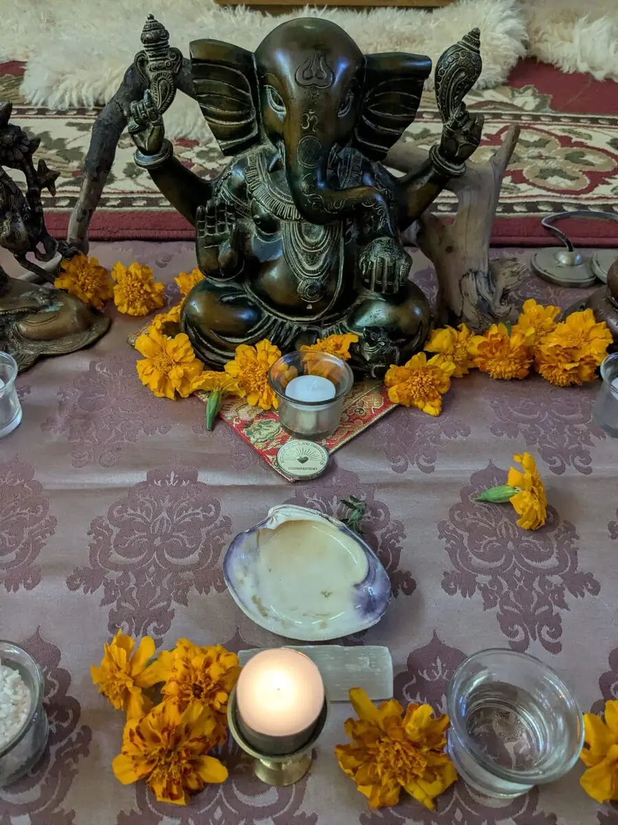 A Ganesha statue with fresh floral offerings