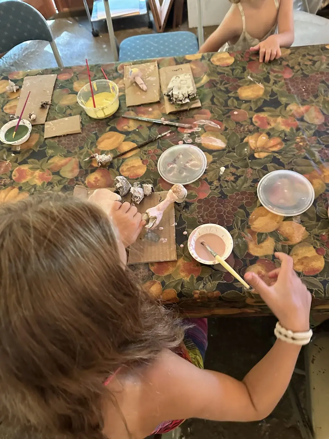 Hands preparing food to share at a table