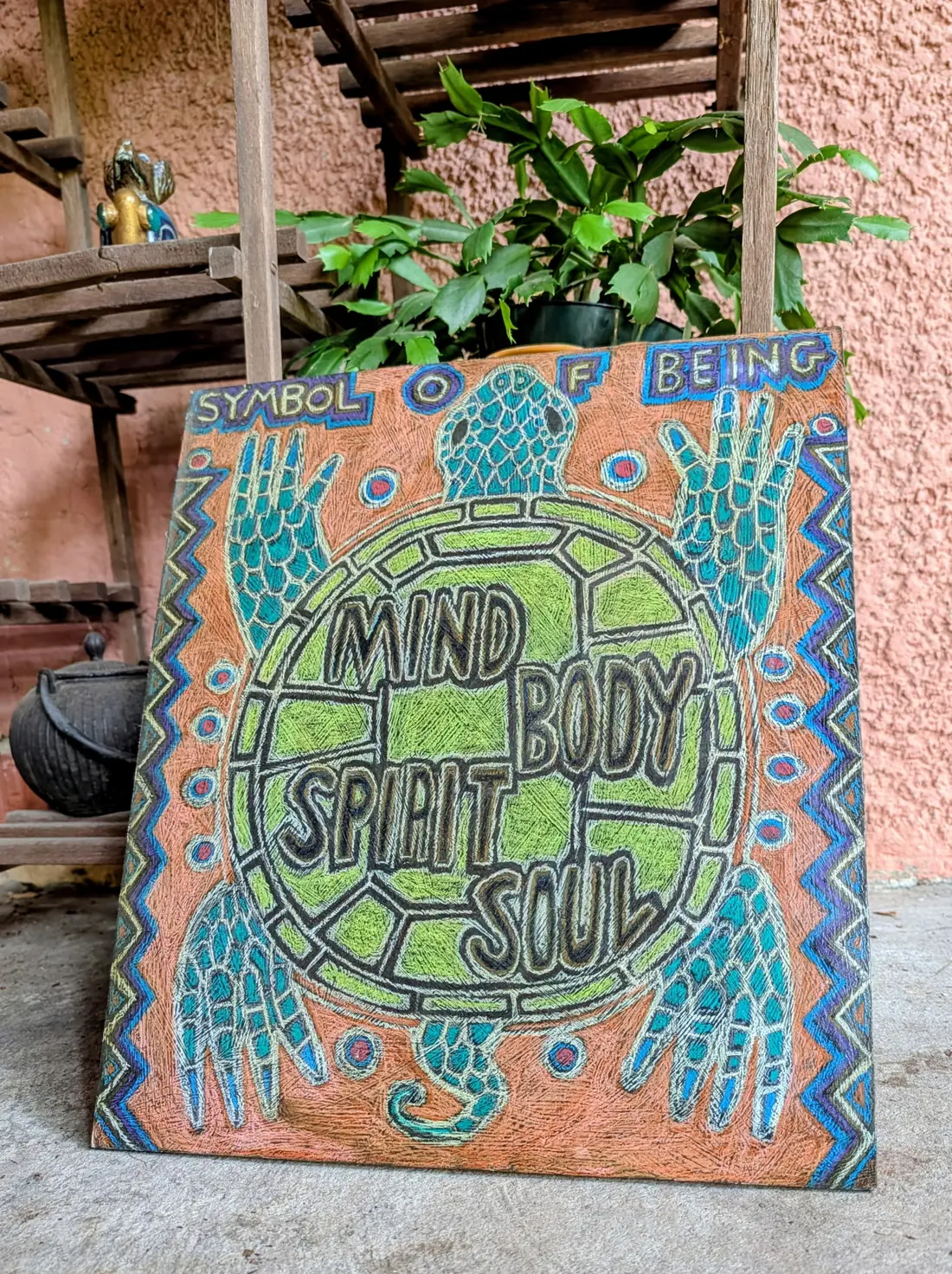 A colorful hand-painted sign reading Mind Body Spirit Soul